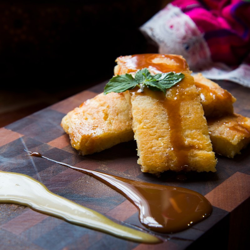 a piece of cake sitting on top of a wooden cutting board