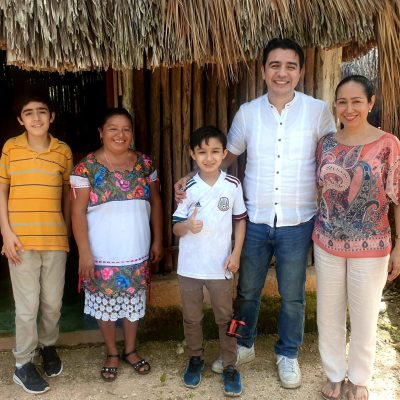 a group of people standing next to a little girl posing for a picture