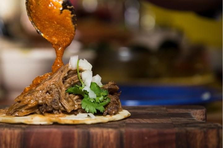a close up of a sandwich sitting on top of a wooden table