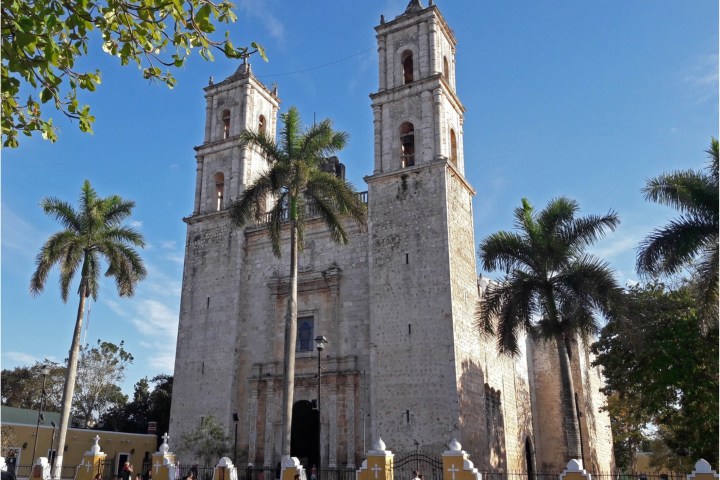 a church with a clock tower in front of a building