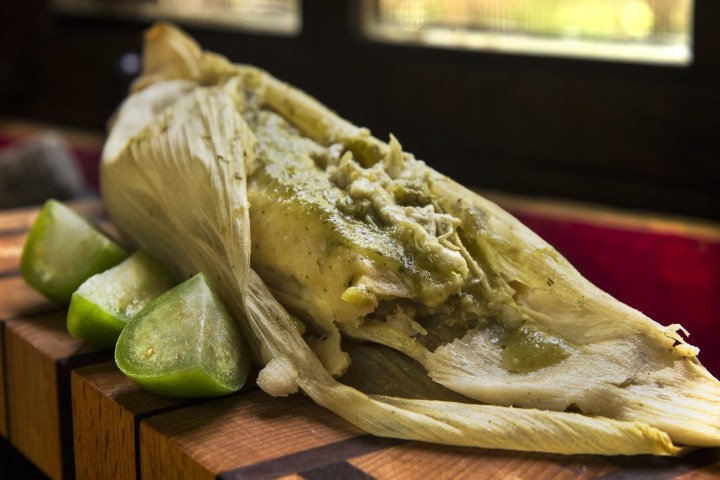 a close up of a sandwich sitting on top of a wooden cutting board