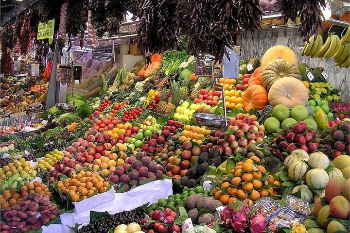 a variety of fruits and vegetables on display at a fruit stand