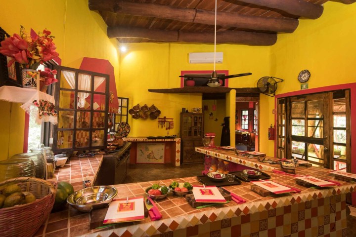 a room filled with furniture and vase of flowers on a table