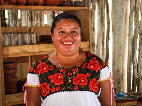 a person standing in front of a cake