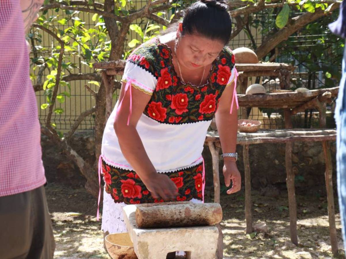 a couple of people standing next to a fence